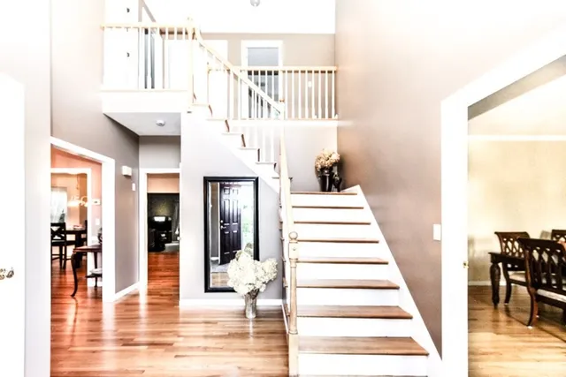 a view of entryway and hall with wooden floor