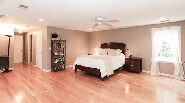 a bedroom with a large bed closet and a window