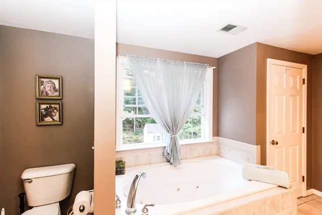 a bath tub sitting in a bathroom next to a window