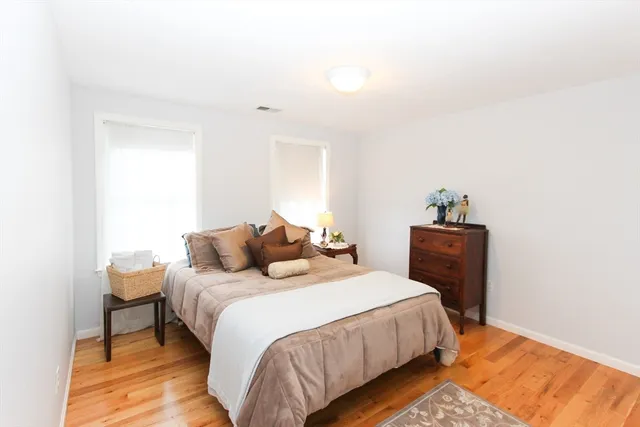 a bedroom with a bed and a lamp on table