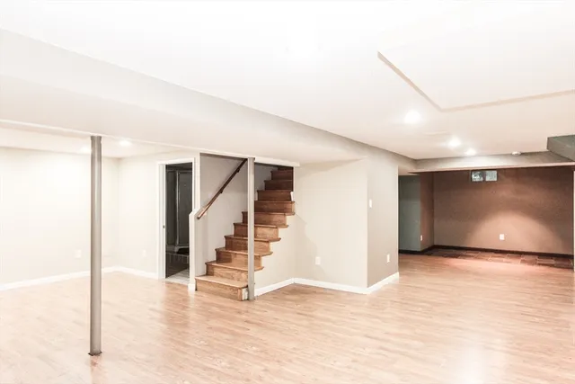 a view of an empty room with stairs and ventilation