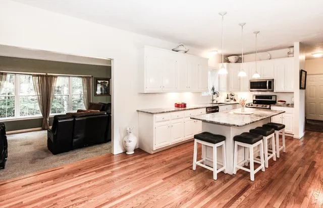 a kitchen with a sink cabinets and wooden floor