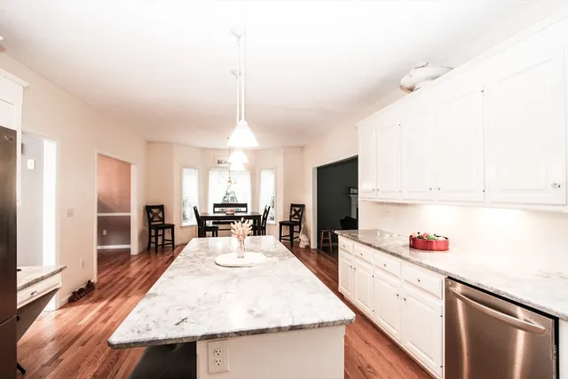 a kitchen with sink refrigerator and cabinets
