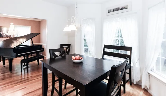 a view of a dining room with furniture and wooden floor