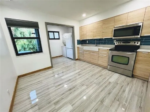 a kitchen with stainless steel appliances a stove top oven and sink