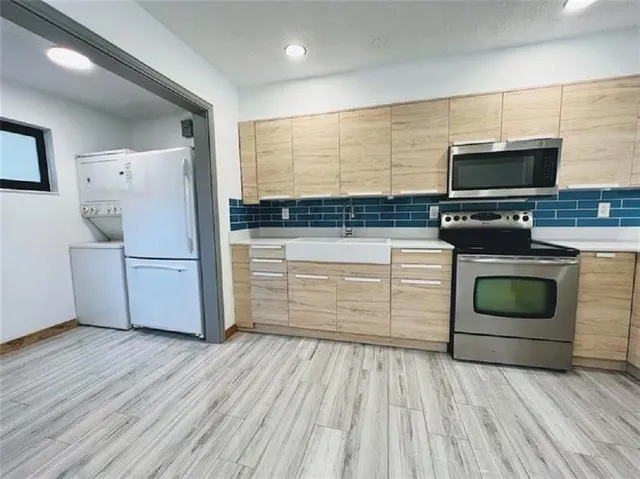 a kitchen with a wooden floor and a stove top oven