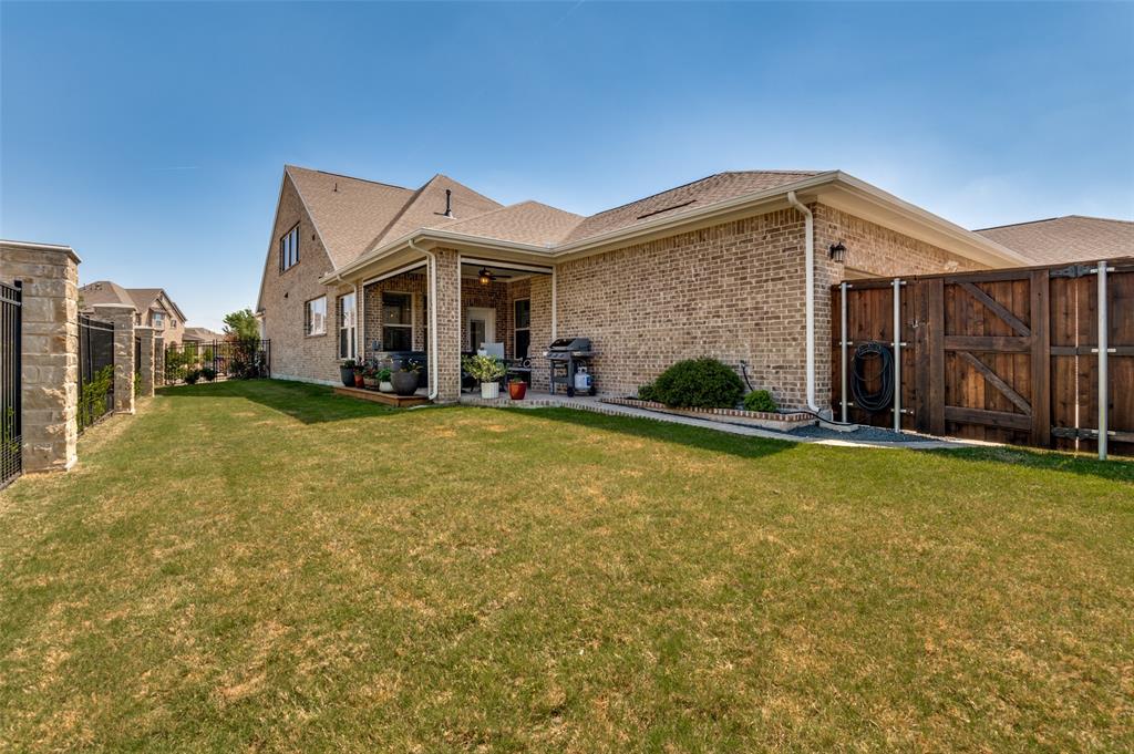 4724 Raspberry Spar Court Arlington, TX 76005 - Photo 31 of 40 a view of a house with a yard and garage
