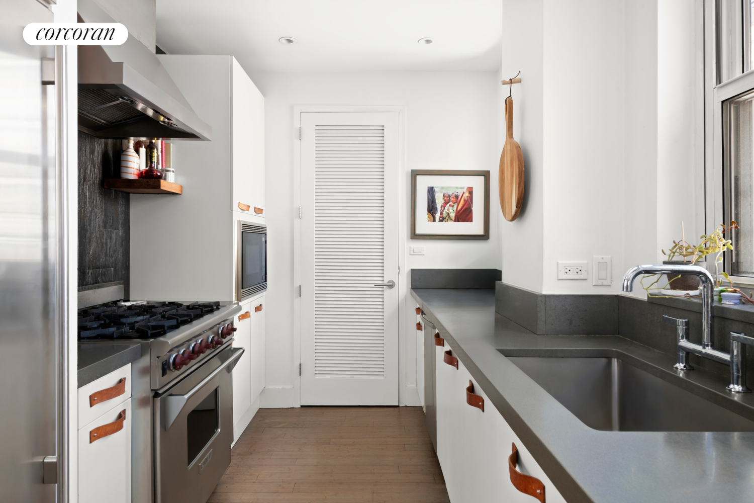130 Fulton Street, Unit 12A Manhattan, NY 10038 - Photo 5 of 17 a kitchen with a sink stove and cabinets