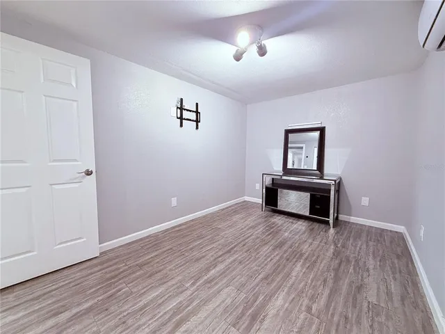 a view of a livingroom with wooden floor and a piano