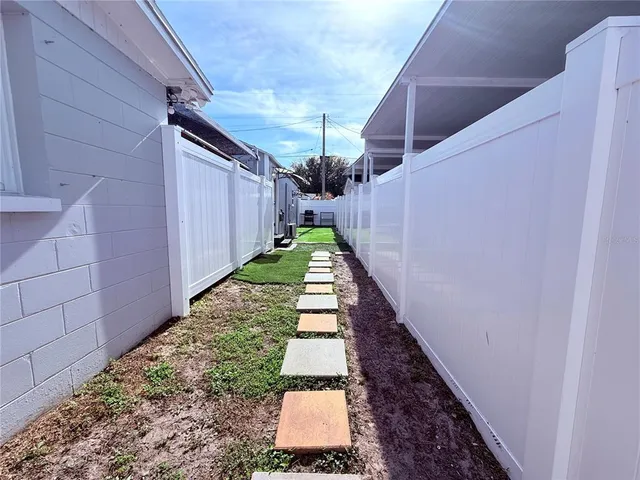 a view of a pathway of a house with a yard