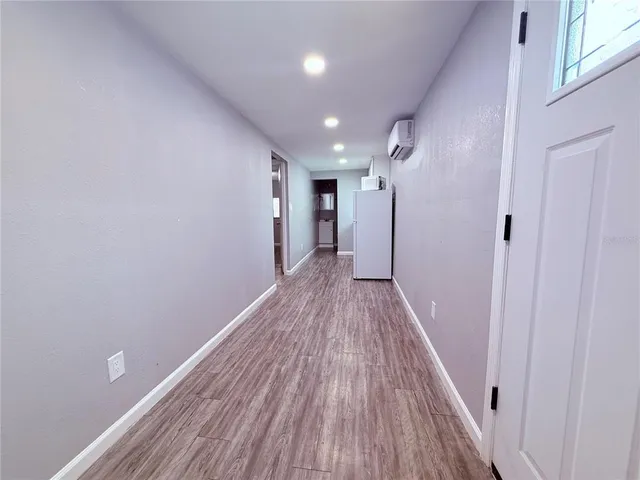 a view of hallway with wooden floor