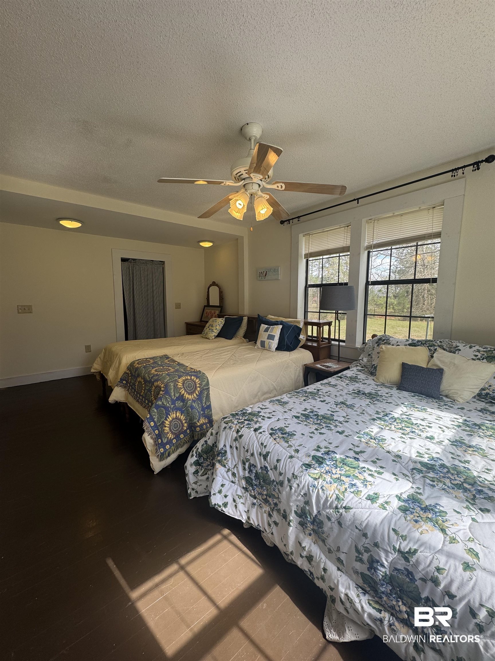 275 Thames Road Frisco City, AL 36445 - Photo 23 of 24 Bedroom with a ceiling fan, a textured ceiling, baseboards, and wood finished floors