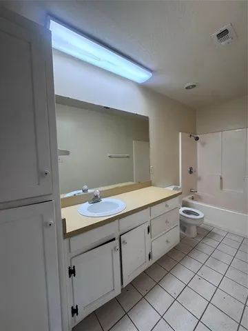 a bathroom with a double vanity sink mirror and toilet