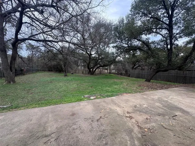 a view of a yard with a tree