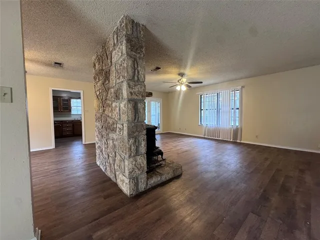 a view of a room with wooden floor staircase and a kitchen