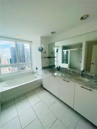 a large bathroom with a large tub and sink