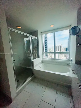 a bathroom with a bathtub and a shower