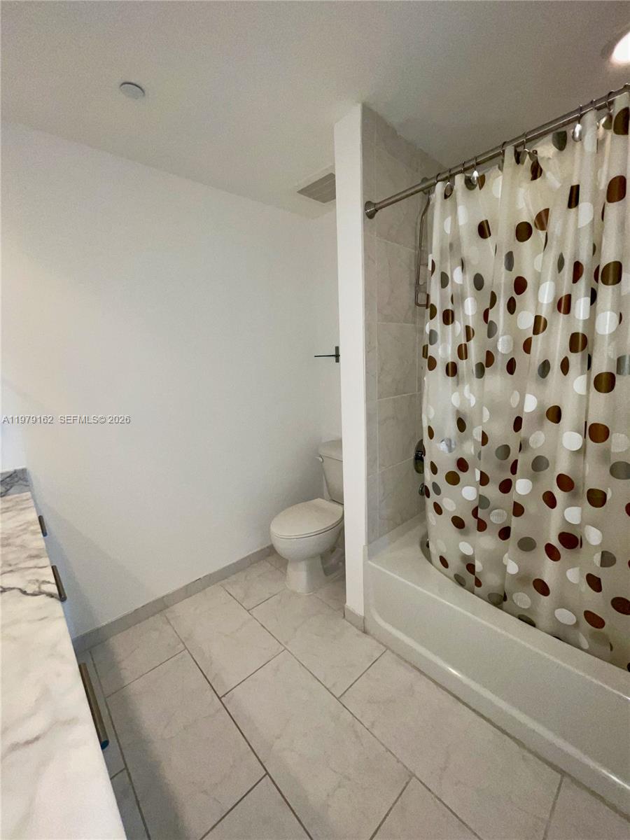 951 Brickell Avenue, Unit 3211 Miami, FL 33131 - Photo 16 of 35 a bathroom with a toilet and a shower