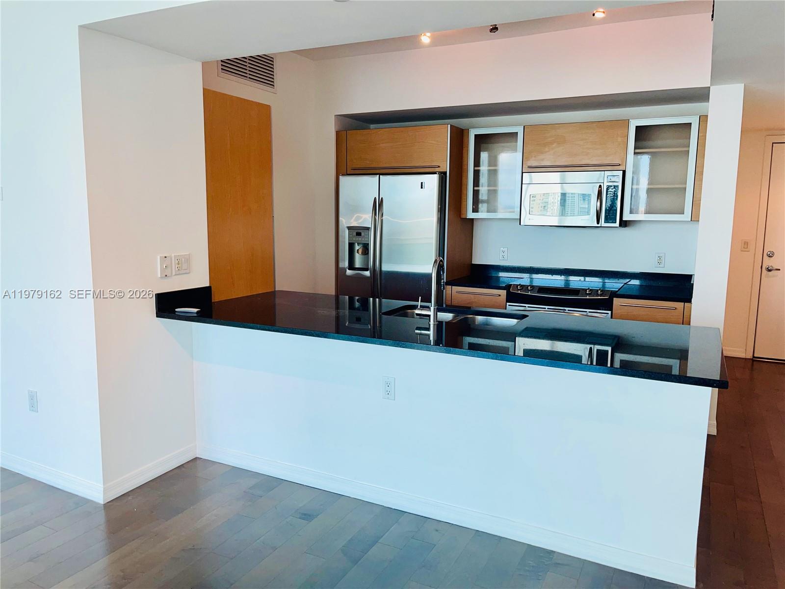 951 Brickell Avenue, Unit 3211 Miami, FL 33131 - Photo 2 of 35 wooden floor in an empty room with a window