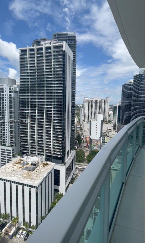 951 Brickell Avenue, Unit 3211 Miami, FL 33131 - Photo 33 of 35 a balcony view with large window and wooden floor