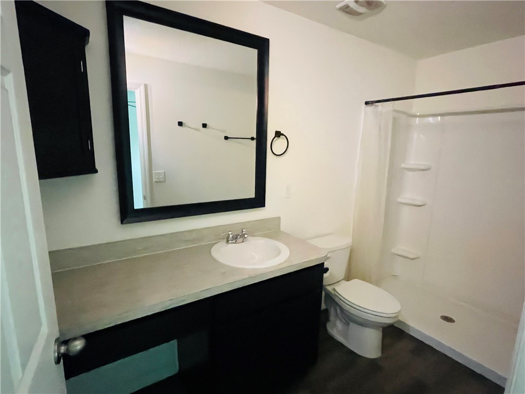 1281 Barber Street Sebastian, FL 32958 - Photo 11 of 26 a bathroom with a granite countertop sink toilet and shower