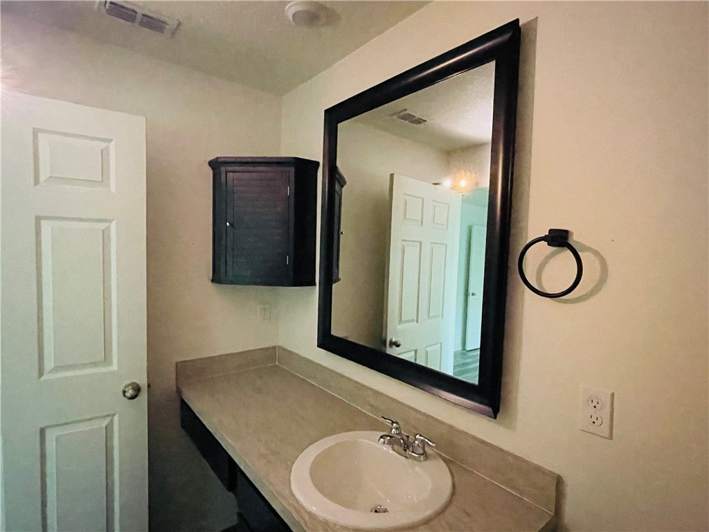 1281 Barber Street Sebastian, FL 32958 - Photo 12 of 26 a bathroom with a sink and a mirror
