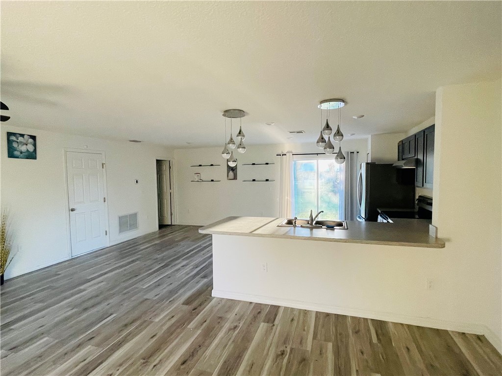 1281 Barber Street Sebastian, FL 32958 - Photo 3 of 26 a view of a living room and kitchen with furniture