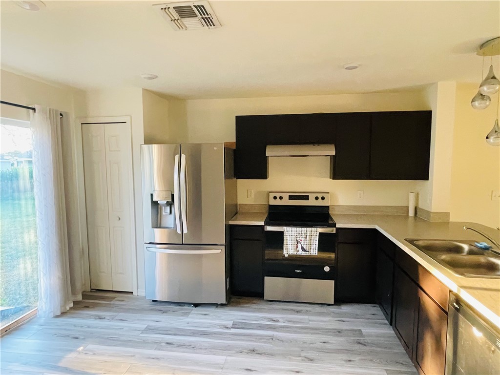 1281 Barber Street Sebastian, FL 32958 - Photo 6 of 26 a kitchen with a refrigerator and a sink