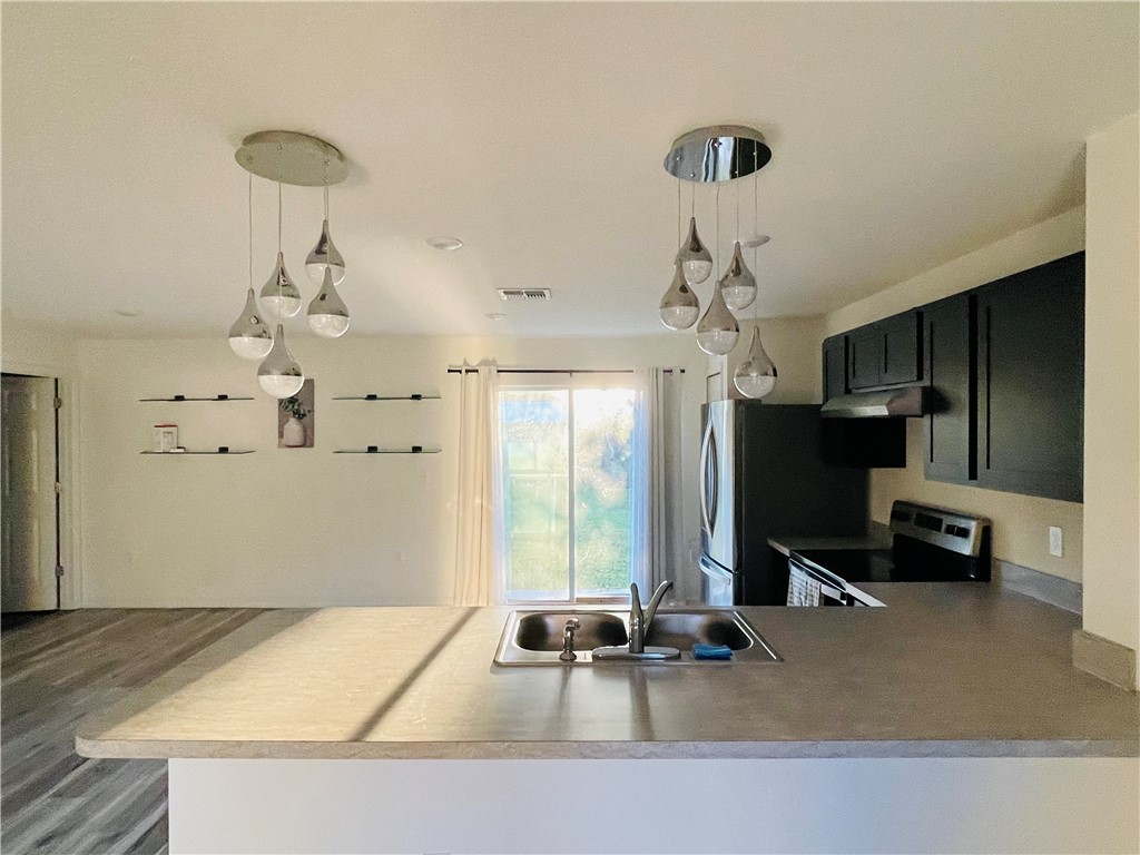 1281 Barber Street Sebastian, FL 32958 - Photo 7 of 26 a room with pool table and a chandelier