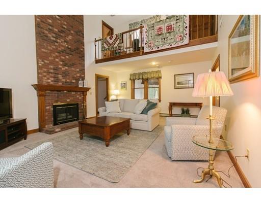 53 Fox Den Road Kingston, MA 02364 - Photo 14 of 30 a living room with furniture a fireplace and a flat screen tv