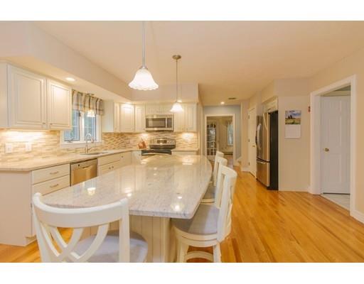 53 Fox Den Road Kingston, MA 02364 - Photo 4 of 30 a kitchen with stainless steel appliances kitchen island granite countertop a sink and cabinets