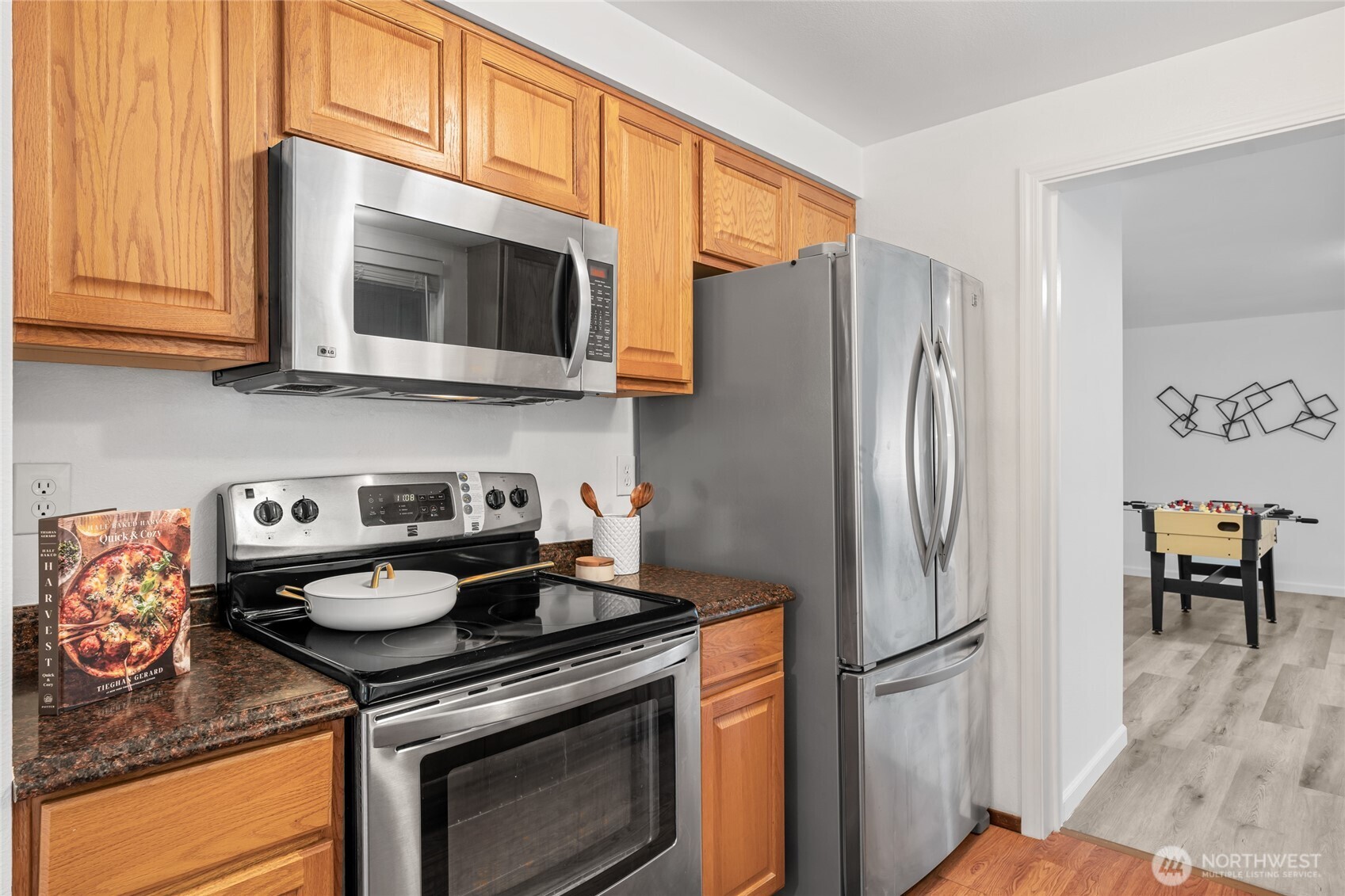 16809 Southeast 149th Street Renton, WA 98059 - Photo 11 of 30 a kitchen with stainless steel appliances granite countertop a stove a refrigerator and a microwave