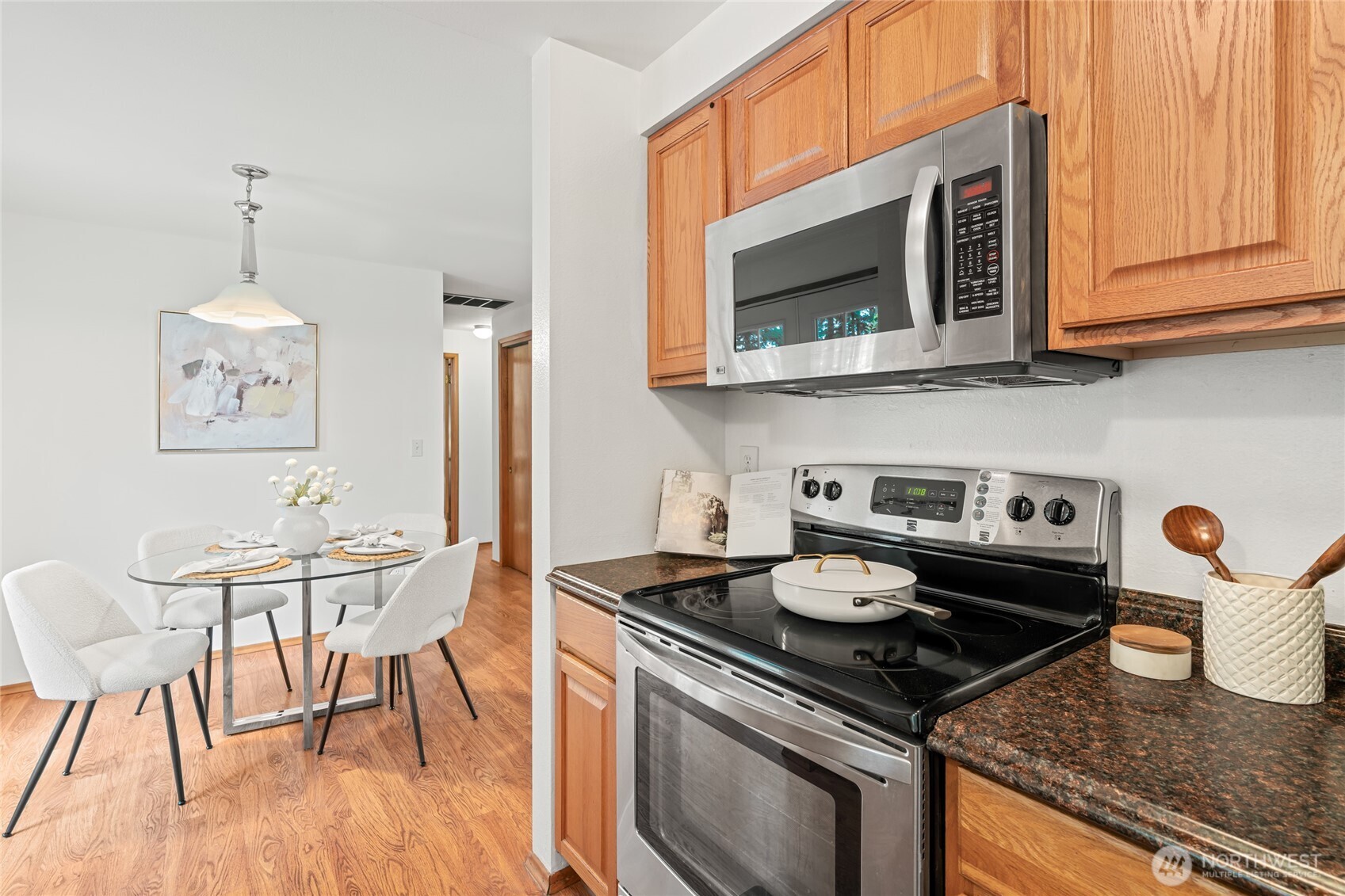 16809 Southeast 149th Street Renton, WA 98059 - Photo 12 of 30 a kitchen with stainless steel appliances granite countertop a stove and a wooden floor