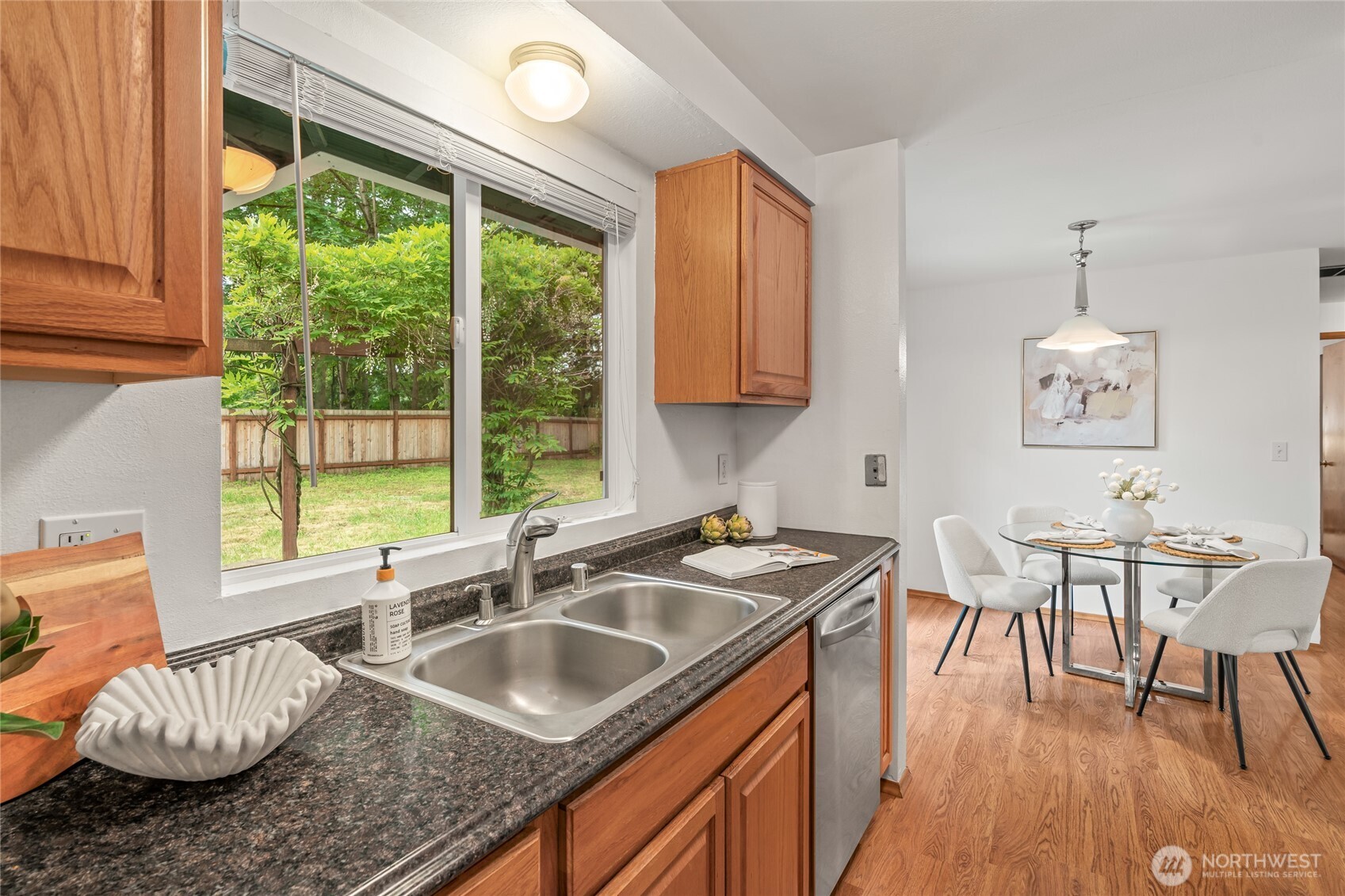 16809 Southeast 149th Street Renton, WA 98059 - Photo 13 of 30 a kitchen that has a sink a table and chairs in it