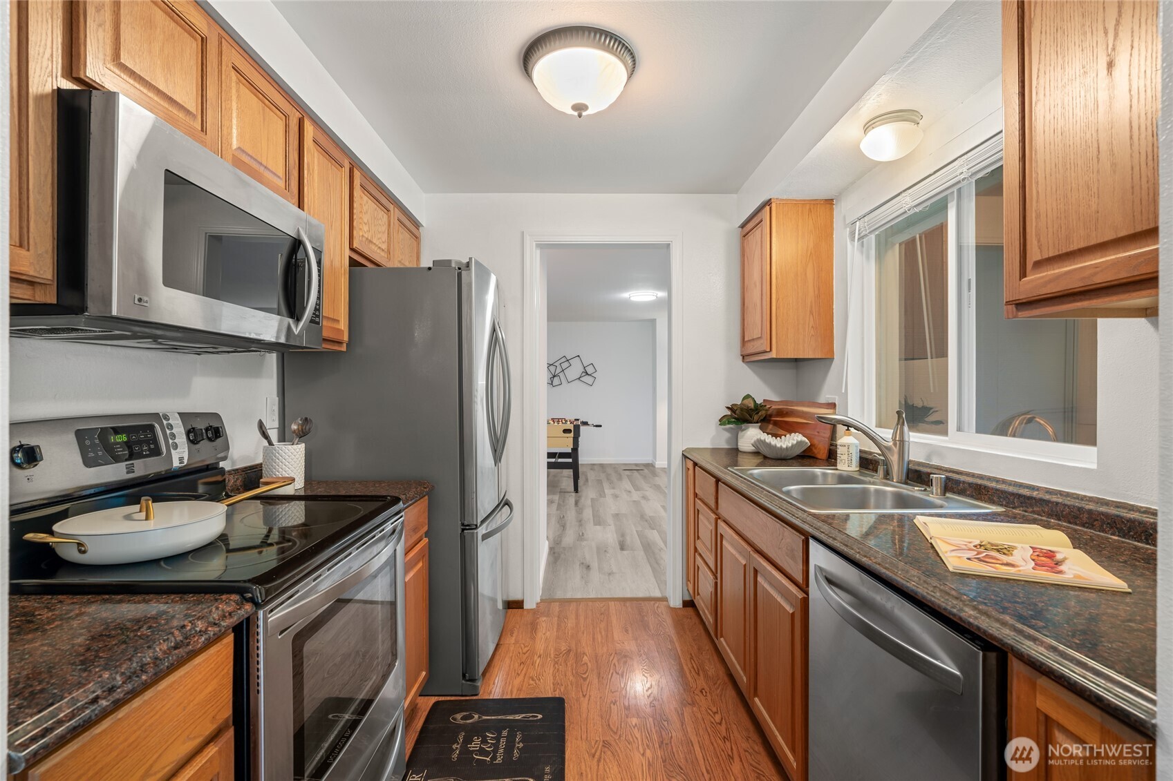 16809 Southeast 149th Street Renton, WA 98059 - Photo 10 of 30 a kitchen with stainless steel appliances granite countertop a sink stove and refrigerator