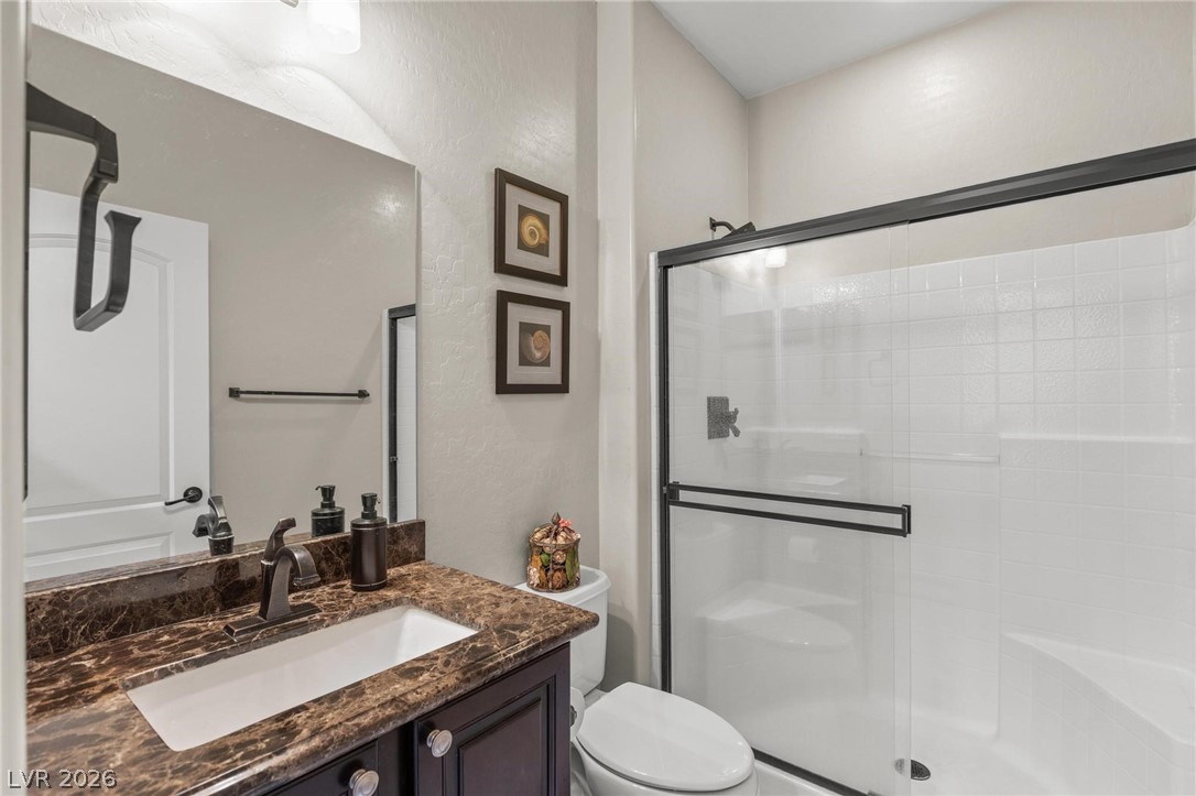 8431 Durango Ranch Court Las Vegas, NV 89113 - Photo 21 of 49 This bathroom features a contemporary shower and a vanity with elegant counters.