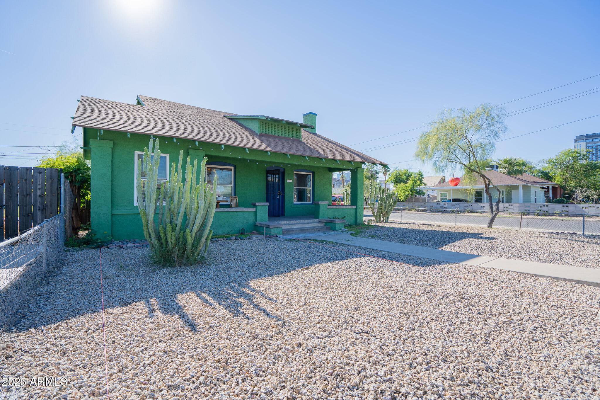 1001 East Garfield Street Phoenix, AZ 85006 - Photo 1 of 27 a front view of a house with a garden and plants