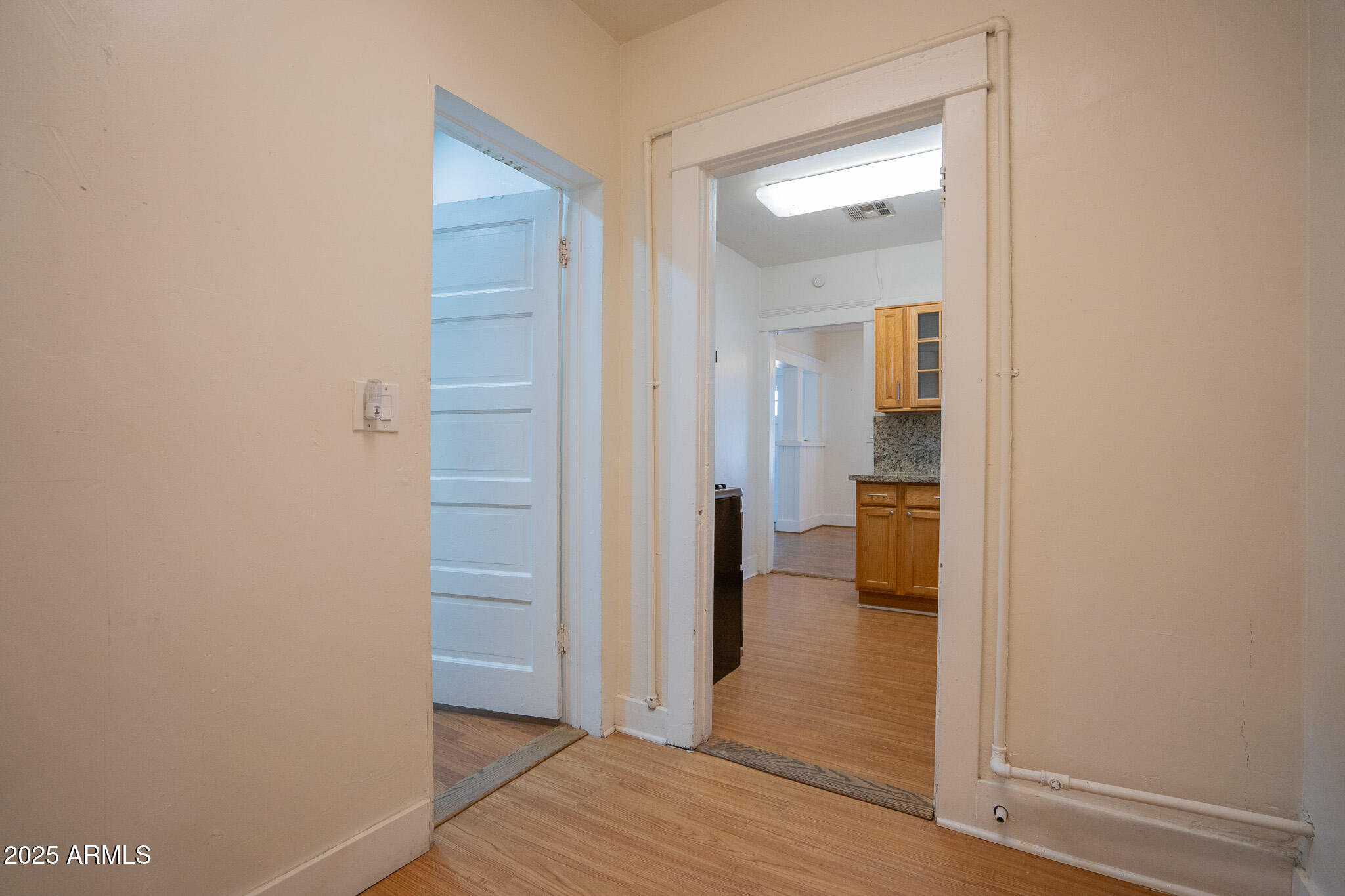 1001 East Garfield Street Phoenix, AZ 85006 - Photo 15 of 27 a view of a hallway with wooden floor and a bathroom