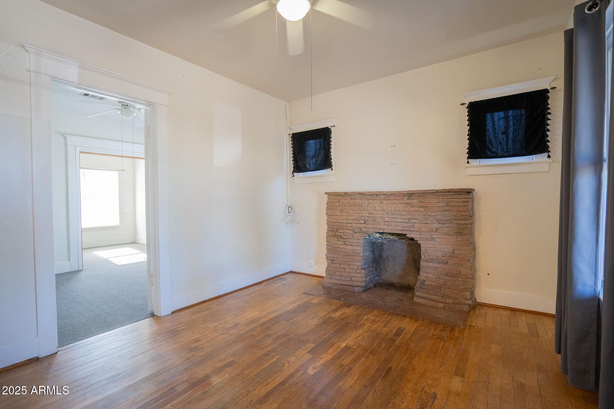 1001 East Garfield Street Phoenix, AZ 85006 - Photo 4 of 27 a view of an empty room with a fireplace and a window
