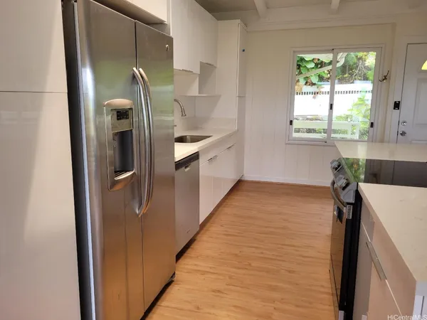 a kitchen with stainless steel appliances a refrigerator and a stove