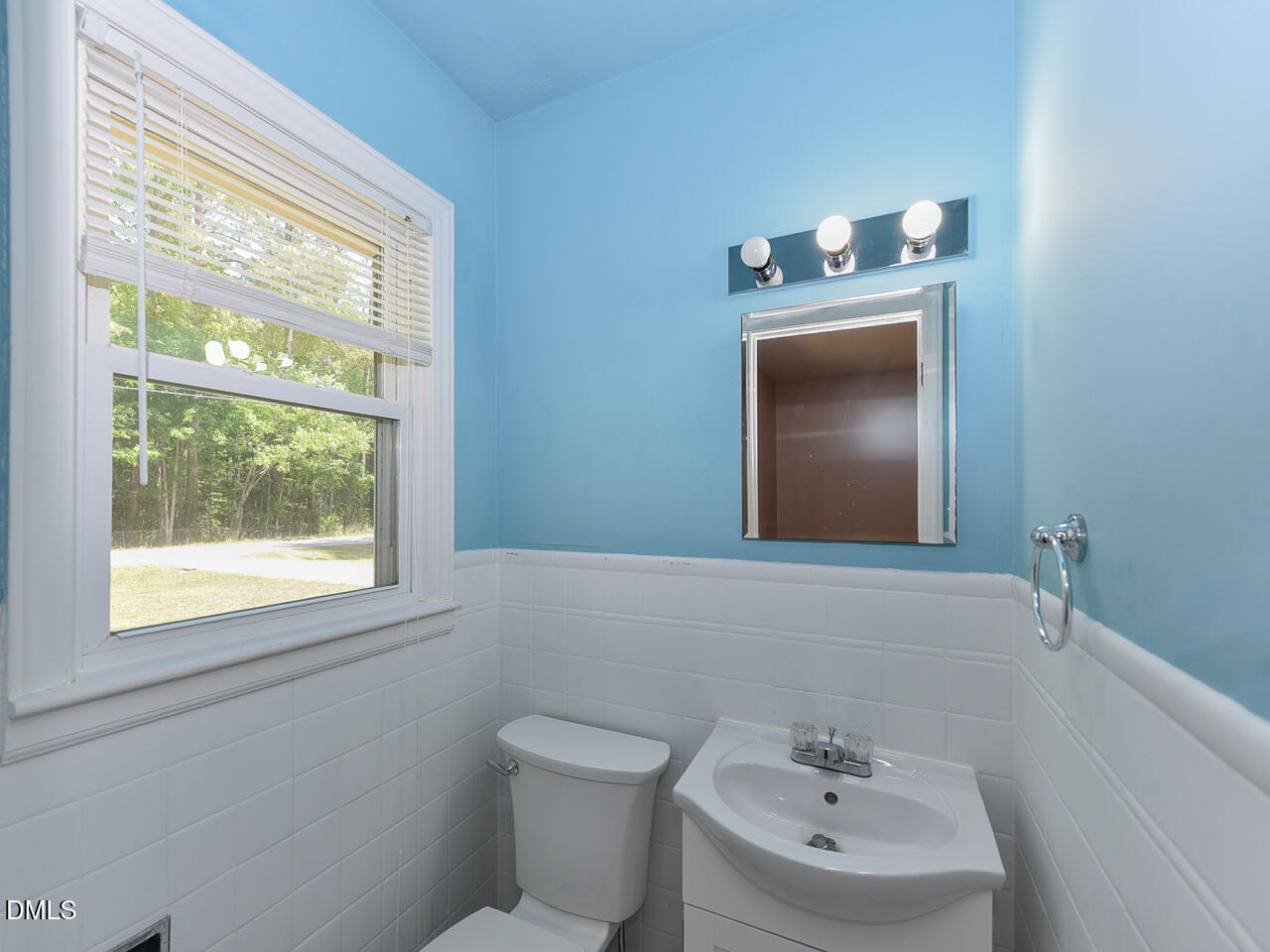 1703 St Patrick Drive Raleigh, NC 27603 - Photo 15 of 29 a bathroom with a toilet sink and mirror