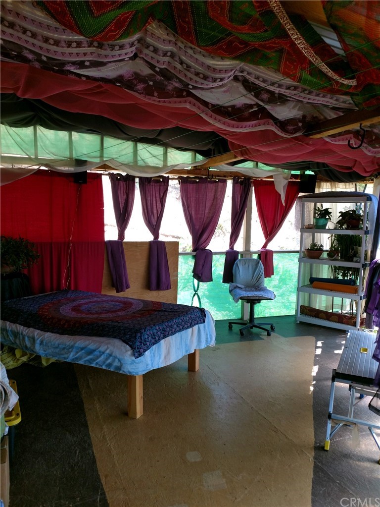 4236 Kakini Road Oroville, CA 95965 - Photo 13 of 36 a view of a patio with table and chairs under an umbrella