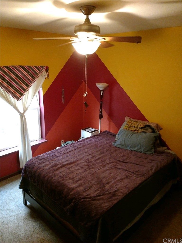 4236 Kakini Road Oroville, CA 95965 - Photo 6 of 36 a bed sitting in a bedroom next to a window