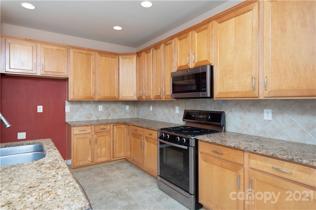 638 Amethyst Circle Fort Mill, SC 29708 - Photo 11 of 38 a kitchen with stainless steel appliances granite countertop a stove a sink and a microwave