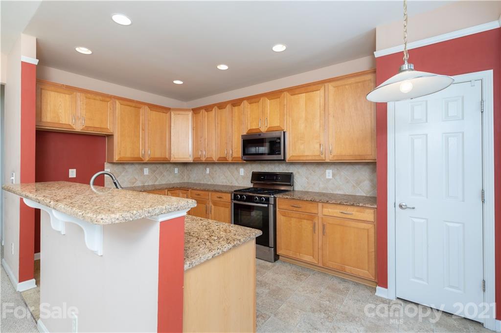 638 Amethyst Circle Fort Mill, SC 29708 - Photo 12 of 38 a kitchen with a sink a microwave a stove and cabinets