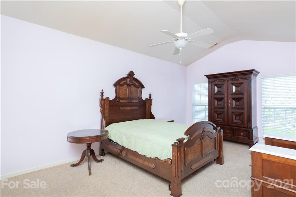 638 Amethyst Circle Fort Mill, SC 29708 - Photo 14 of 38 a bedroom with a bed and a chandelier