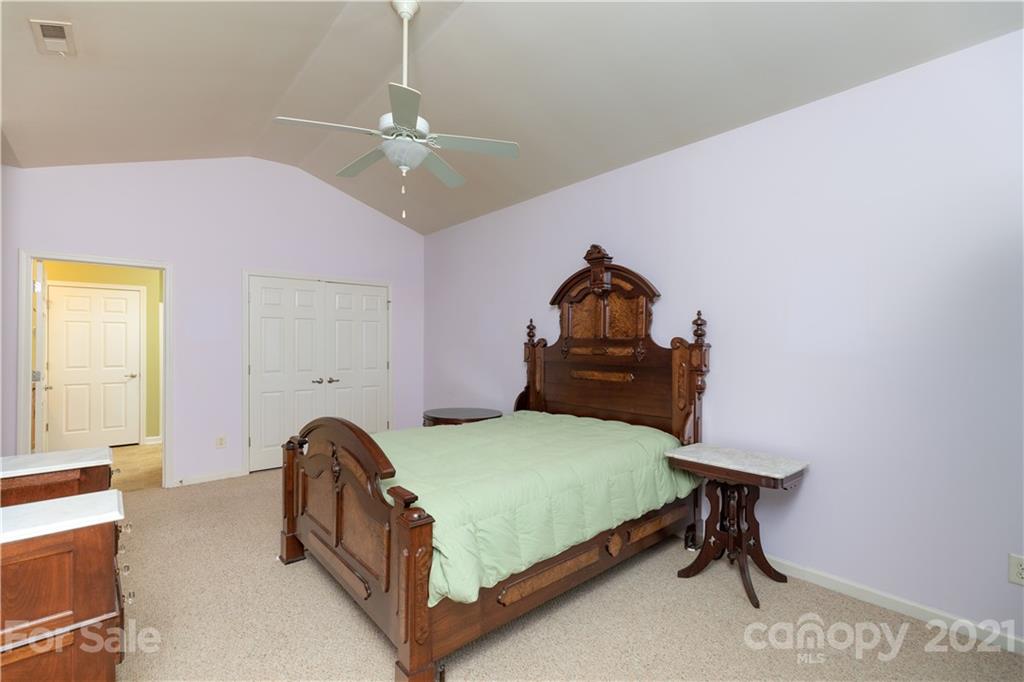 638 Amethyst Circle Fort Mill, SC 29708 - Photo 15 of 38 a bedroom with a bed and a chandelier