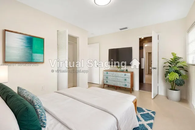 a en suite bathroom with a granite countertop sink and a mirror