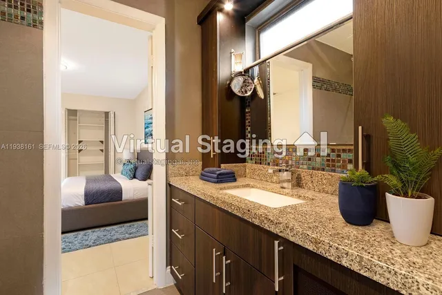 a bathroom with a granite countertop sink and a mirror