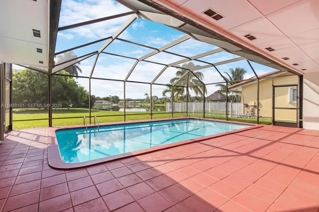 a view of a backyard with a swimming pool